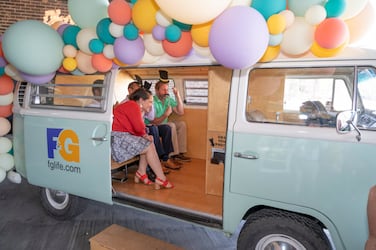 F&G Employees taking a photo together in VW van that was converted into a photobooth 